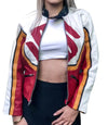 Person wearing a colorful jacket with red, yellow, and white patterns on a white background