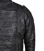 Close-up of a black leather jacket with zippers on a white background
