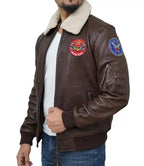 Brown leather jacket with patches on a white background