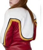 Close-up of a red and white jacket with gold accents on a plain background