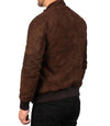 Brown suede jacket worn by a person on a white background