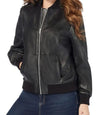 Black leather jacket worn by a person on a white background