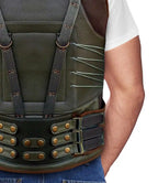 Green tactical vest with brown accents on a person wearing a white shirt and blue jeans.