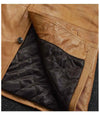 Close-up of a brown leather jacket with quilted black lining