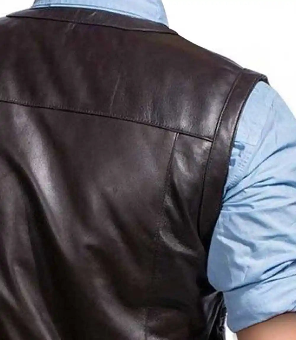 Brown leather vest worn by a person with a light blue shirt underneath.