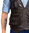 Brown leather vest with multiple pockets and zippers worn over a blue shirt.