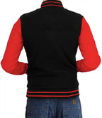 Black and red varsity jacket worn by a person on a white background