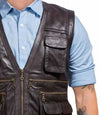 Brown leather vest worn over a light blue shirt on a white background