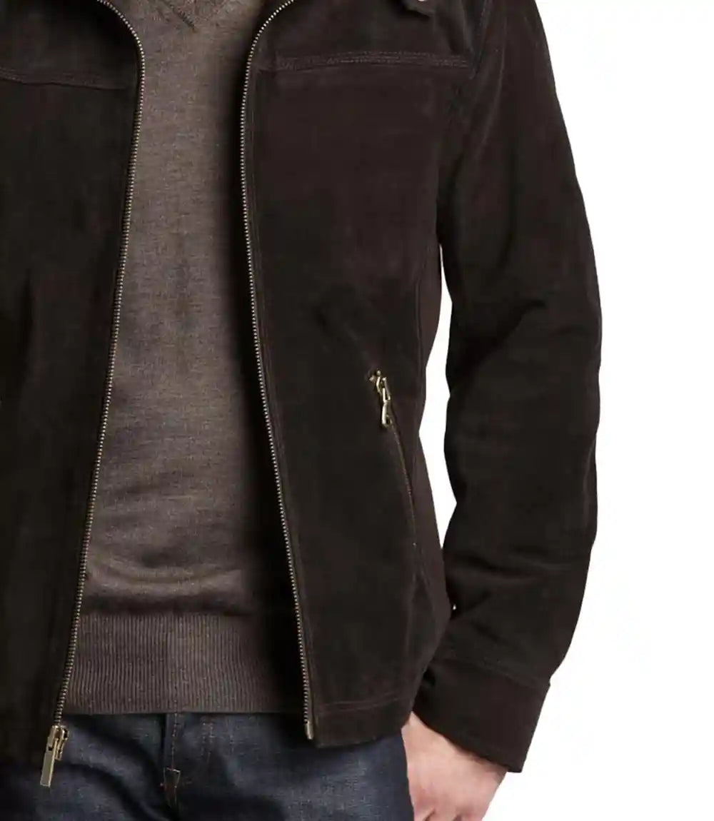 Close-up of a person wearing a dark jacket with a zipper on a white background