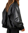 Black leather jacket worn by a person on a white background
